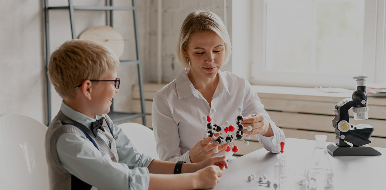 Female science tutor in Baltimore studying chemistry with student